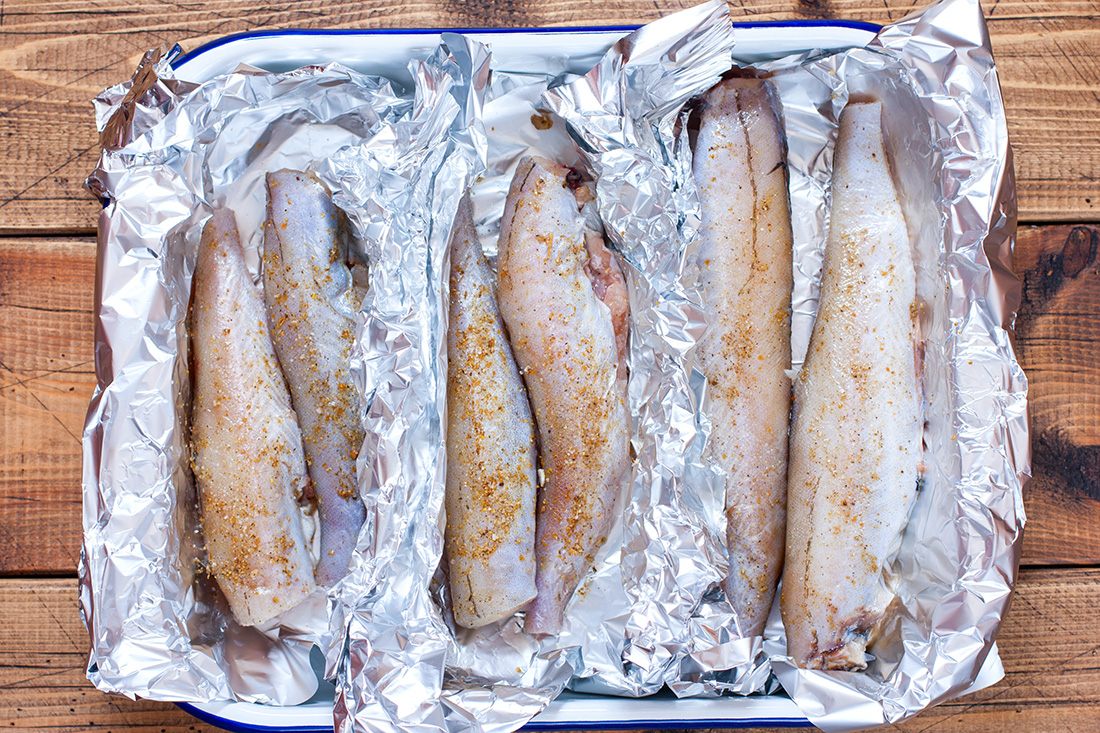 Stepbystep preparation of baked whole pollock in foil in the oven
